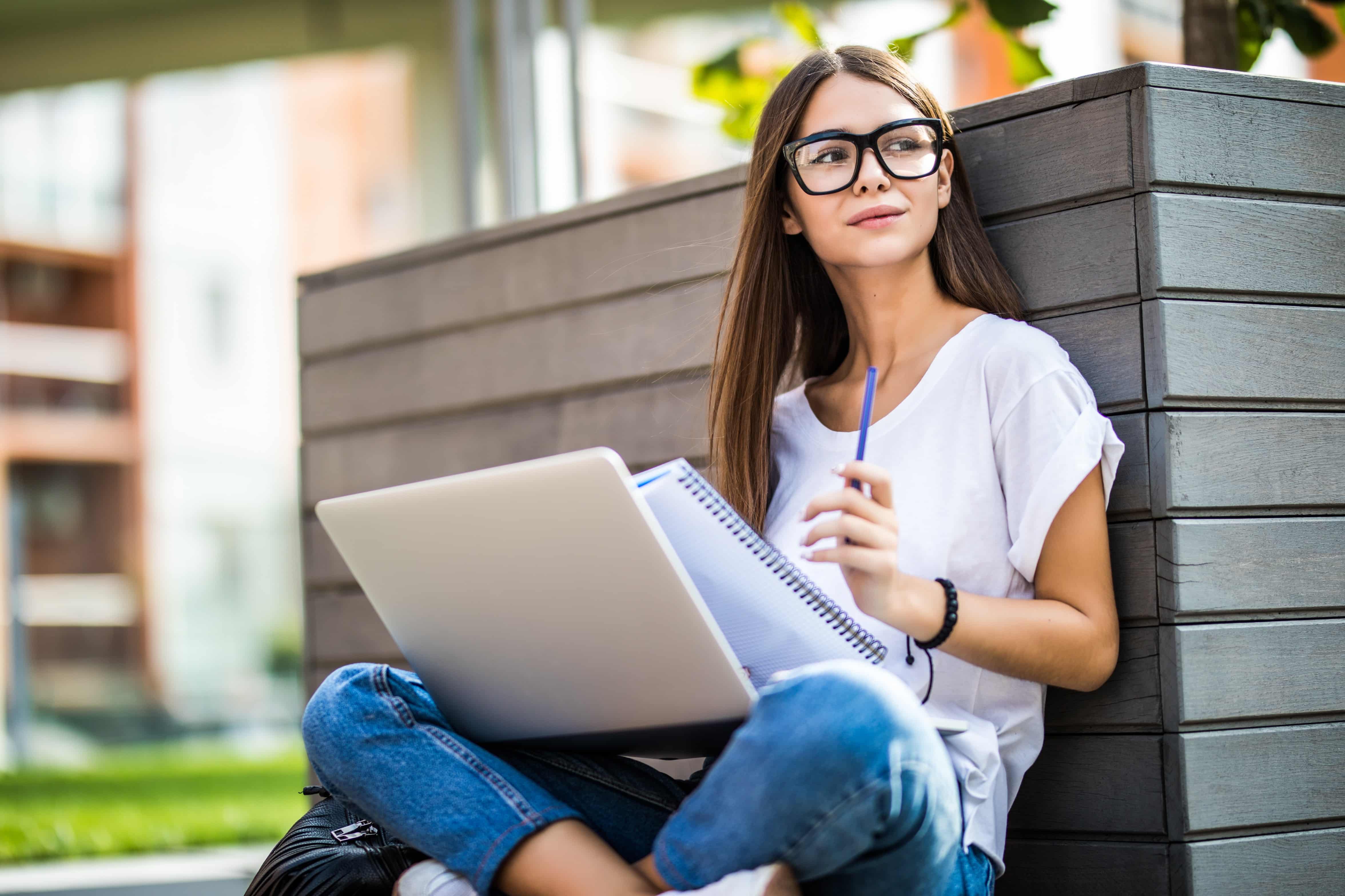 Girl writing 500 word essay for college and scholarships