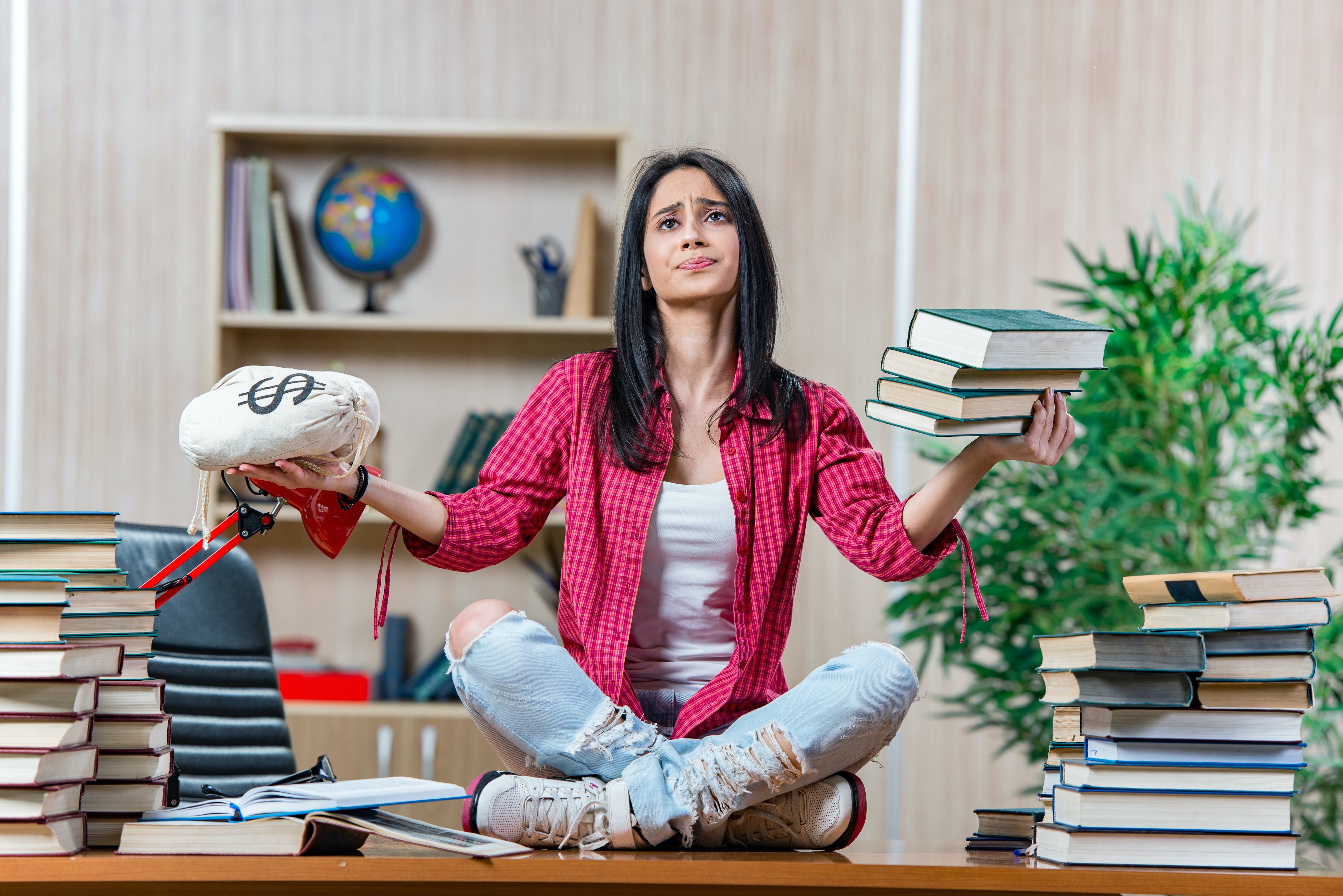 Young woman thinking about student loan debt statistics in 2022